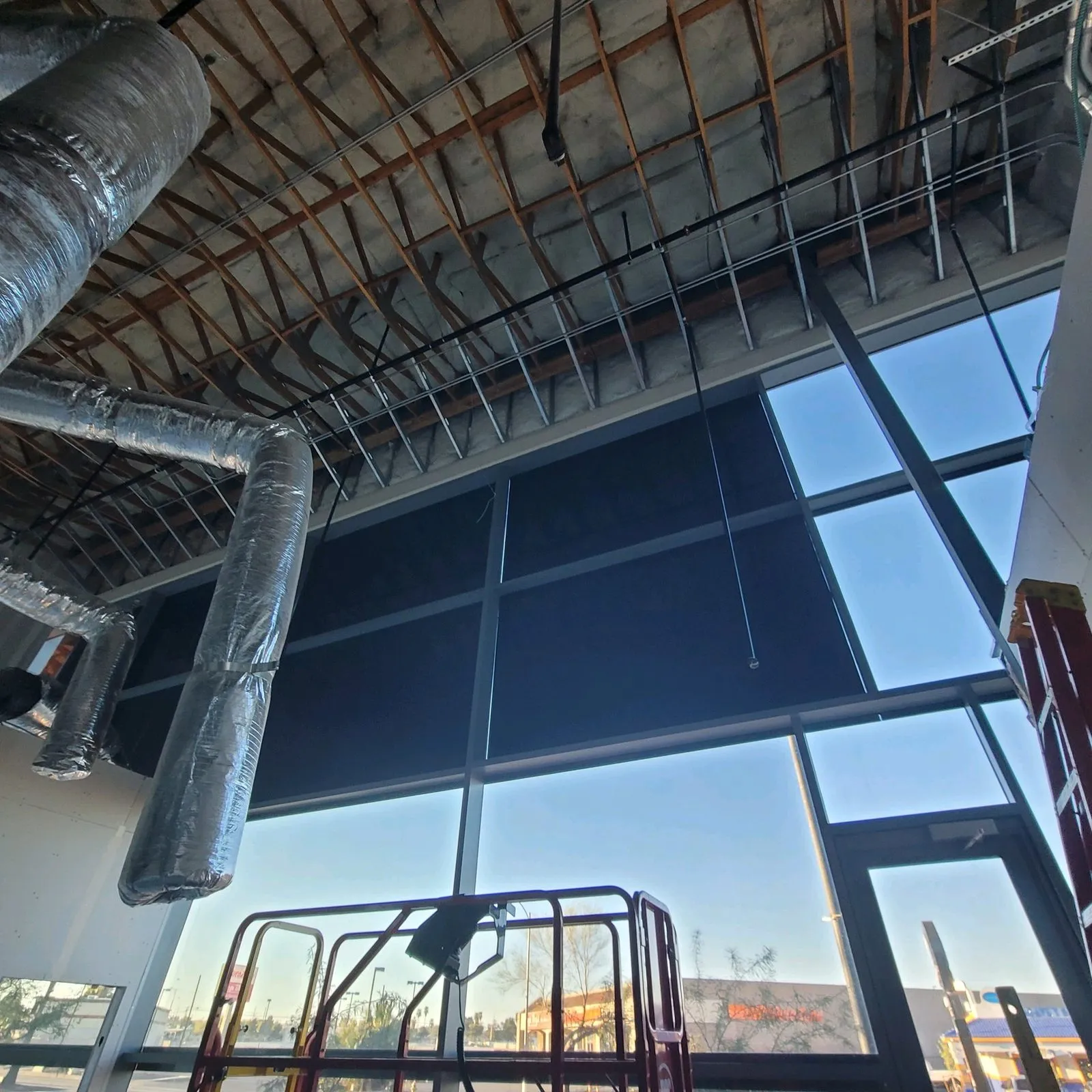 Floor-to-ceiling commercial window tinting with scissor lift Las Vegas