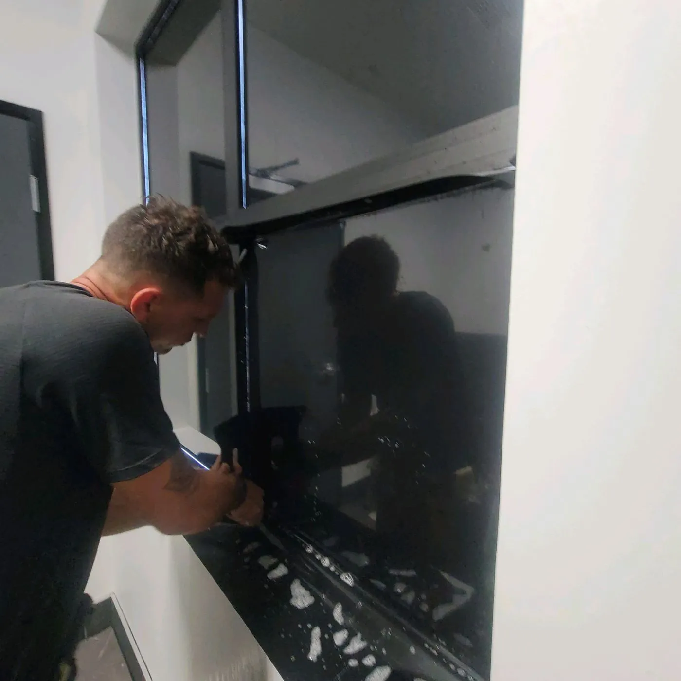Close-up technician pressing edge of solar film into frame