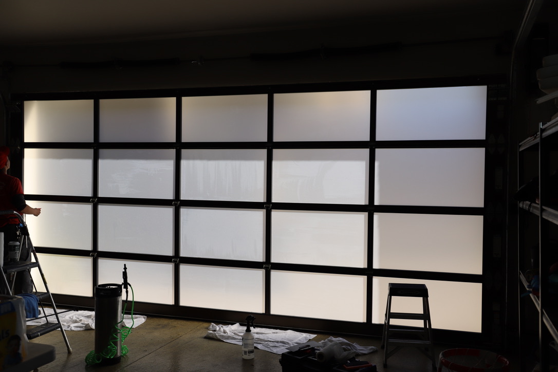 Window film being applied to garage door