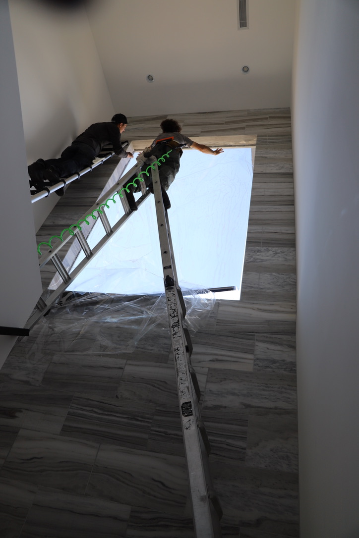 Team installing window film skylight