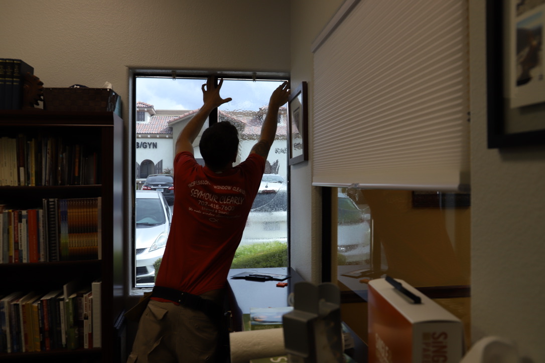 Window film being applied to office window