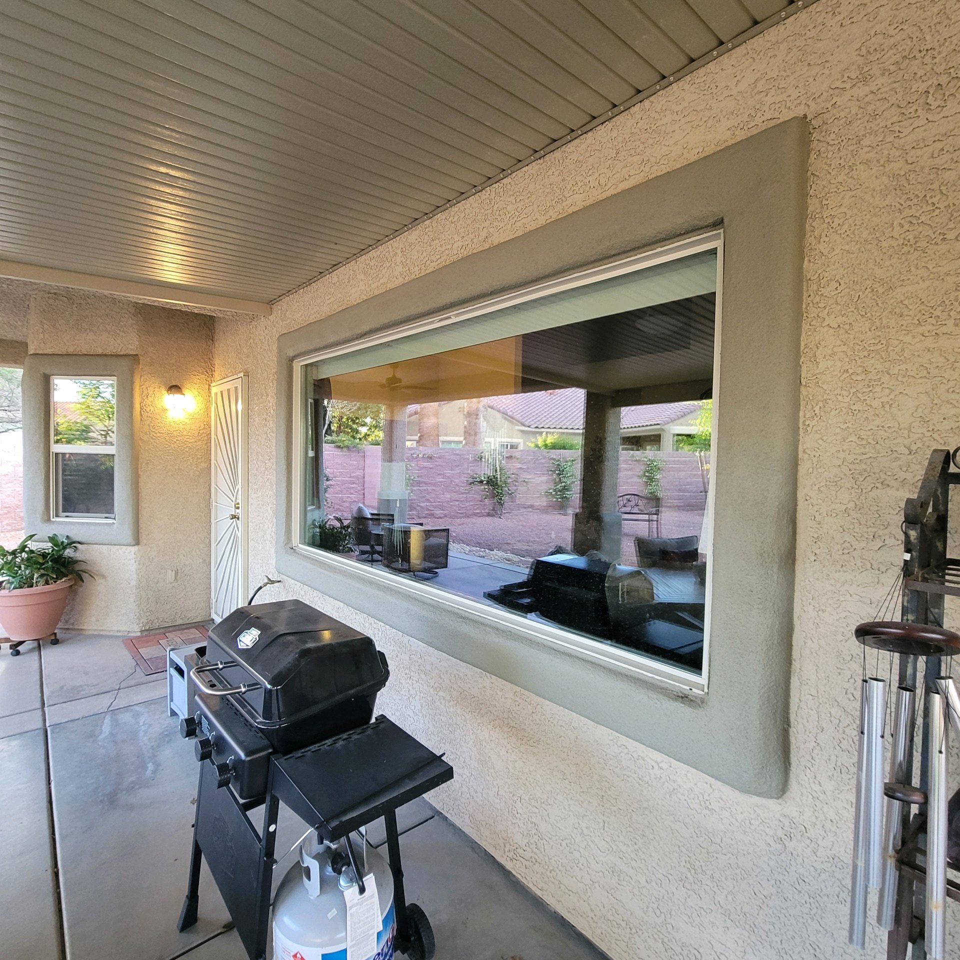 Covered patio home before window tinting wide panoramic window