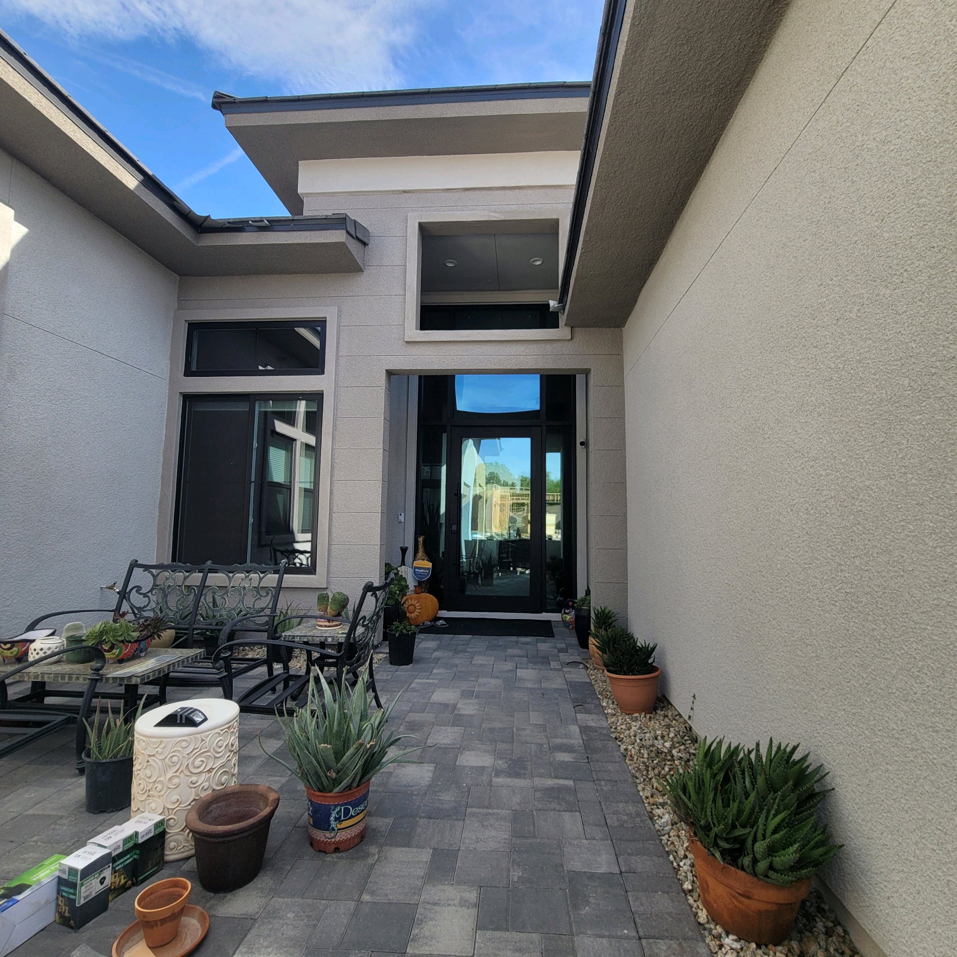 Luxury new construction home before window tinting exterior courtyard