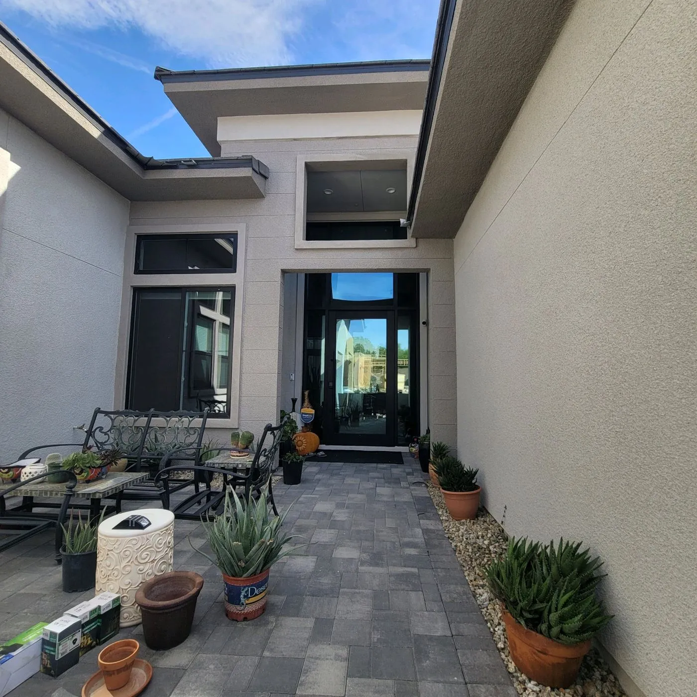 Luxury new construction home before window tinting exterior courtyard
