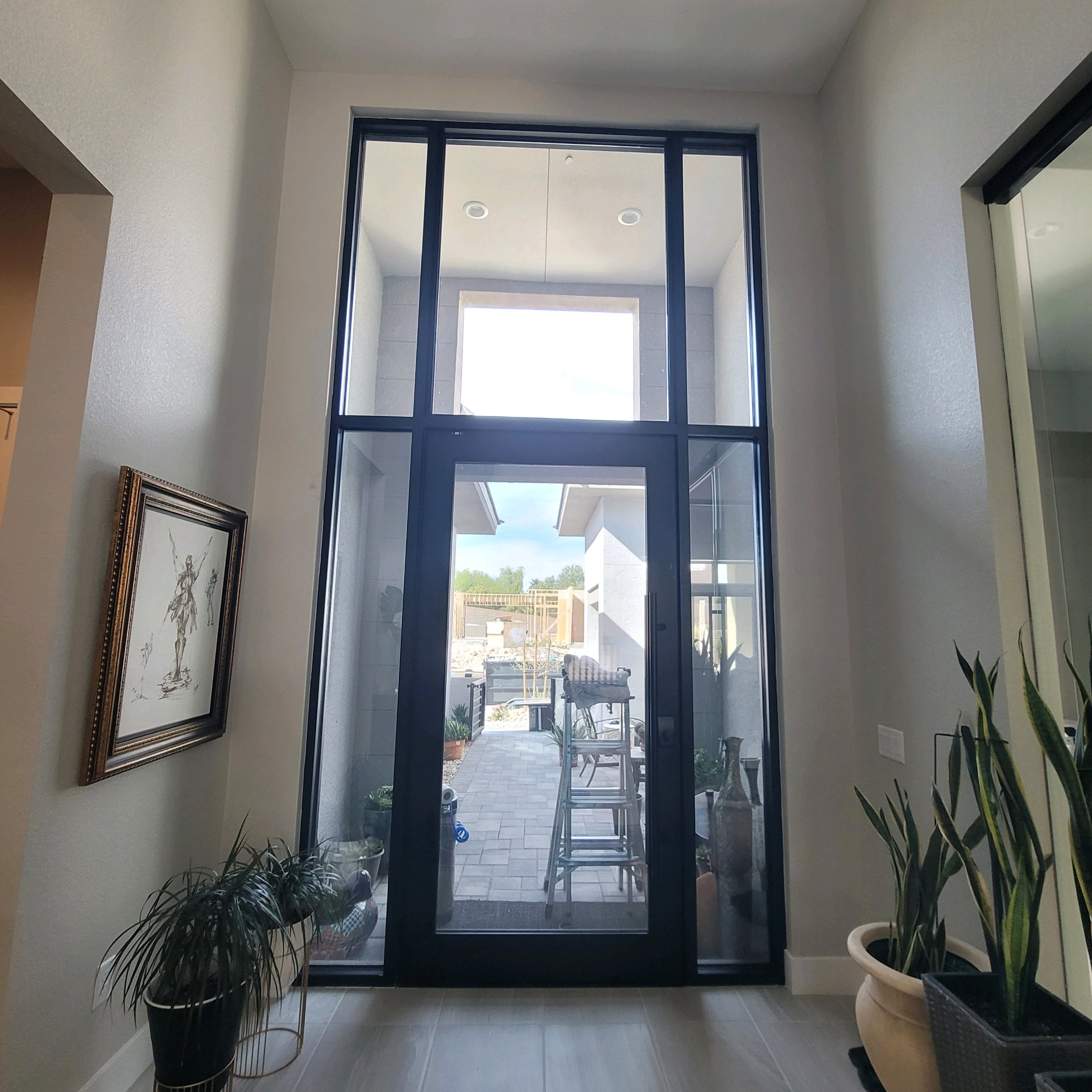 Luxury home interior before solar film foyer