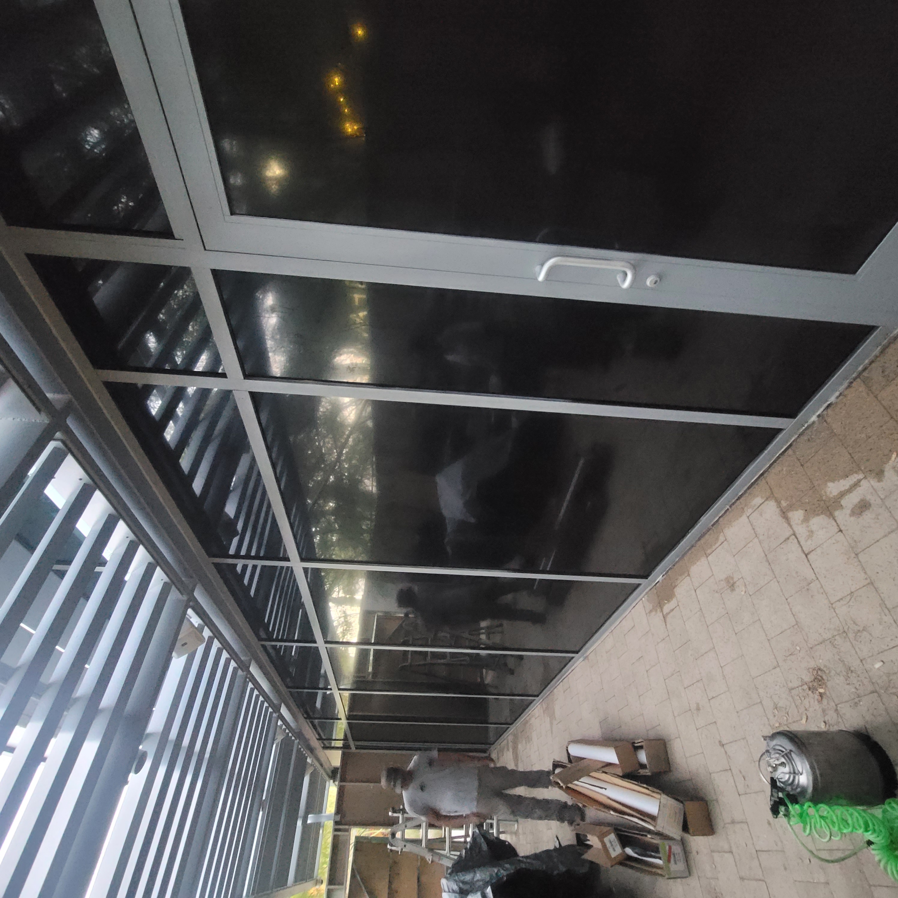 Glass patio enclosure during window film installation blackout film