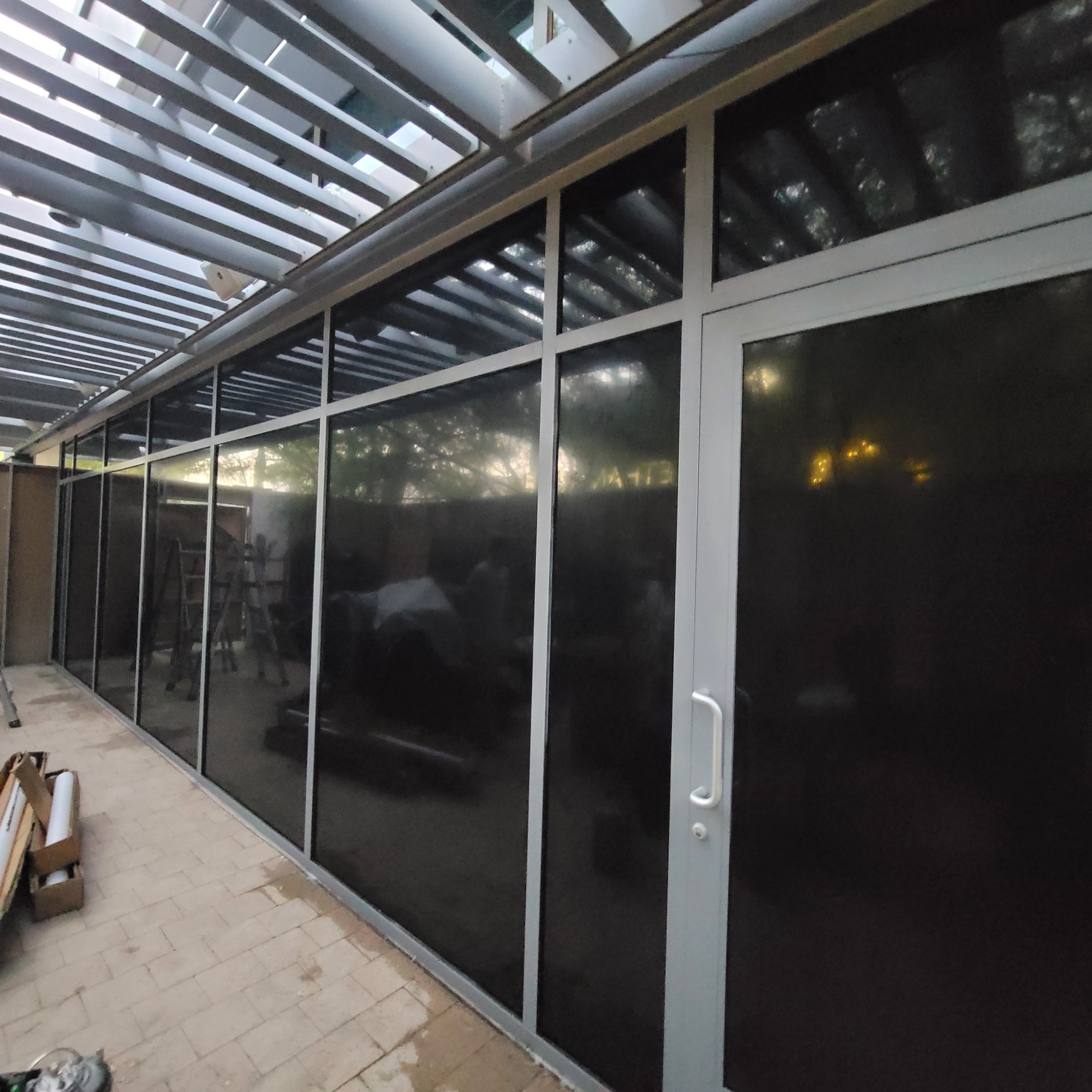 Glass patio enclosure nearly complete solar film installation