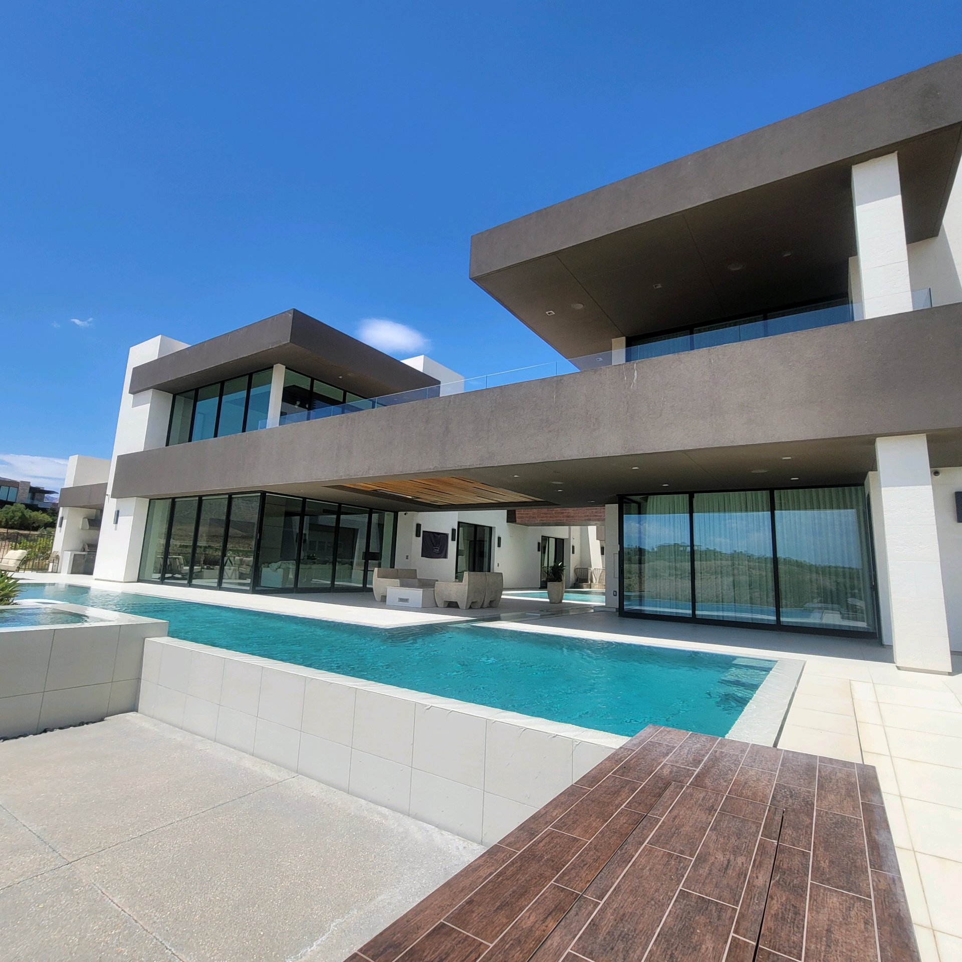 Luxury modern home after window tinting wide angle pool view