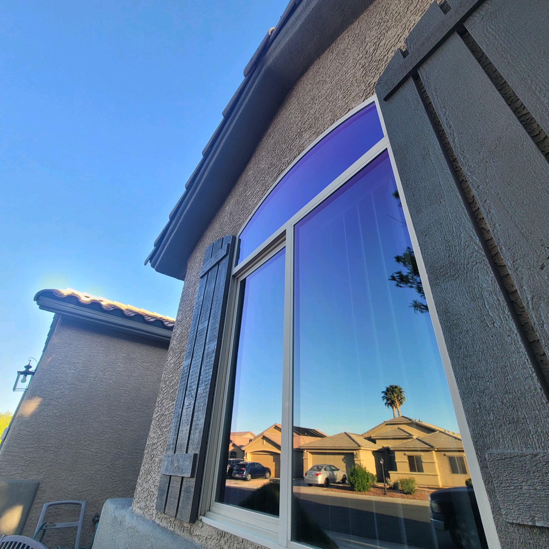 Home with decorative shutters after solar tinting