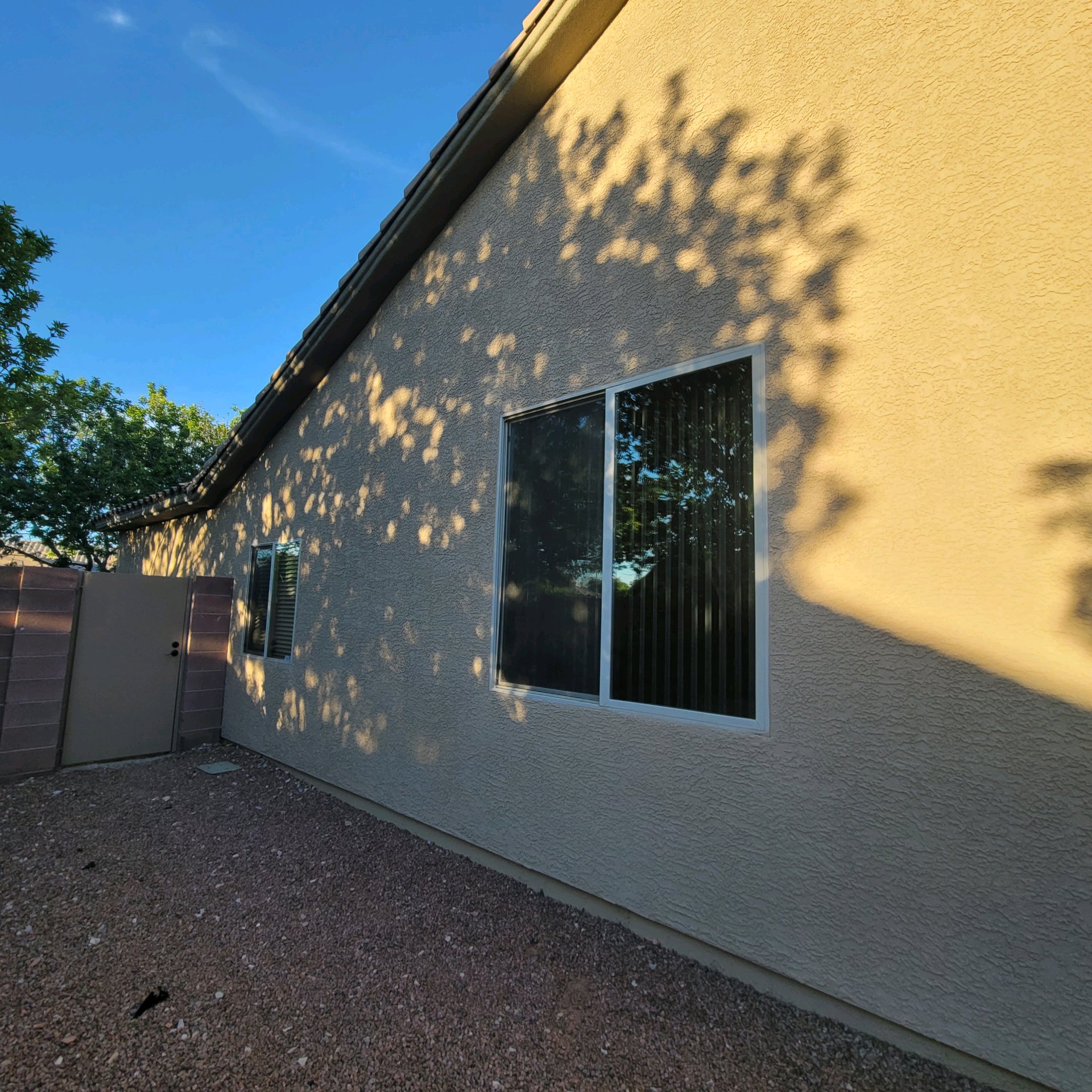 Residential home exterior after solar window film